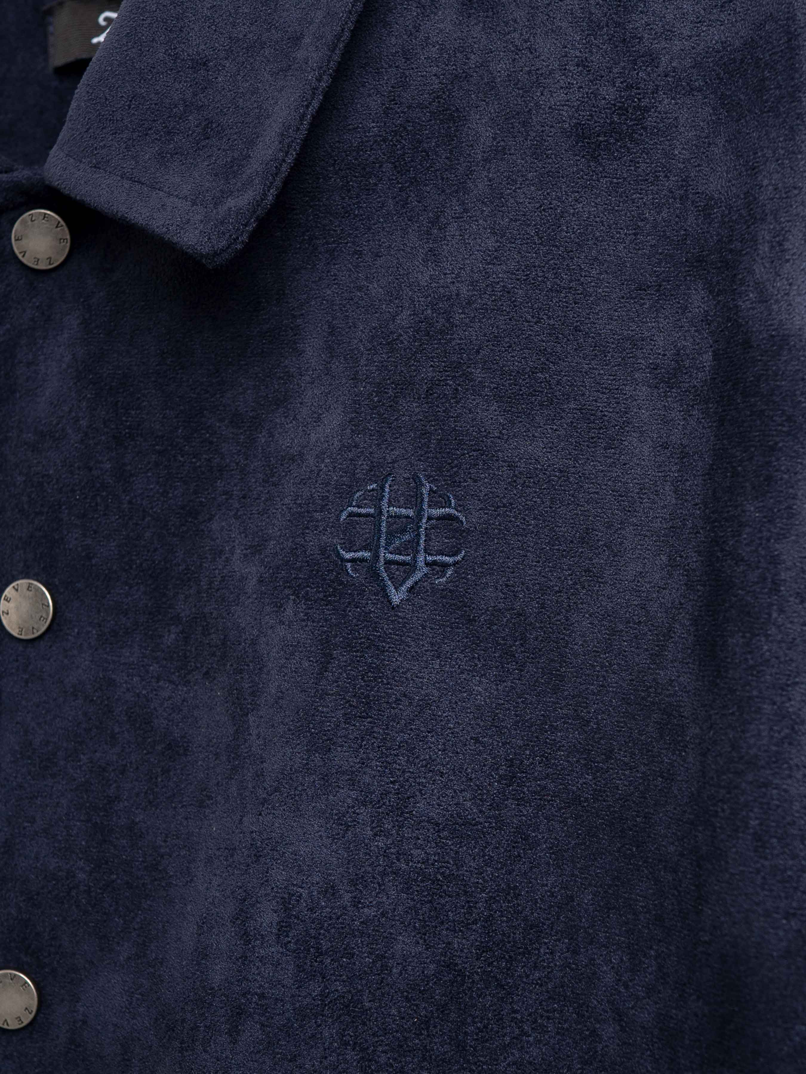 Navy men's jacket with embroidered logo and branded buttons, stylish apparel for formal wear