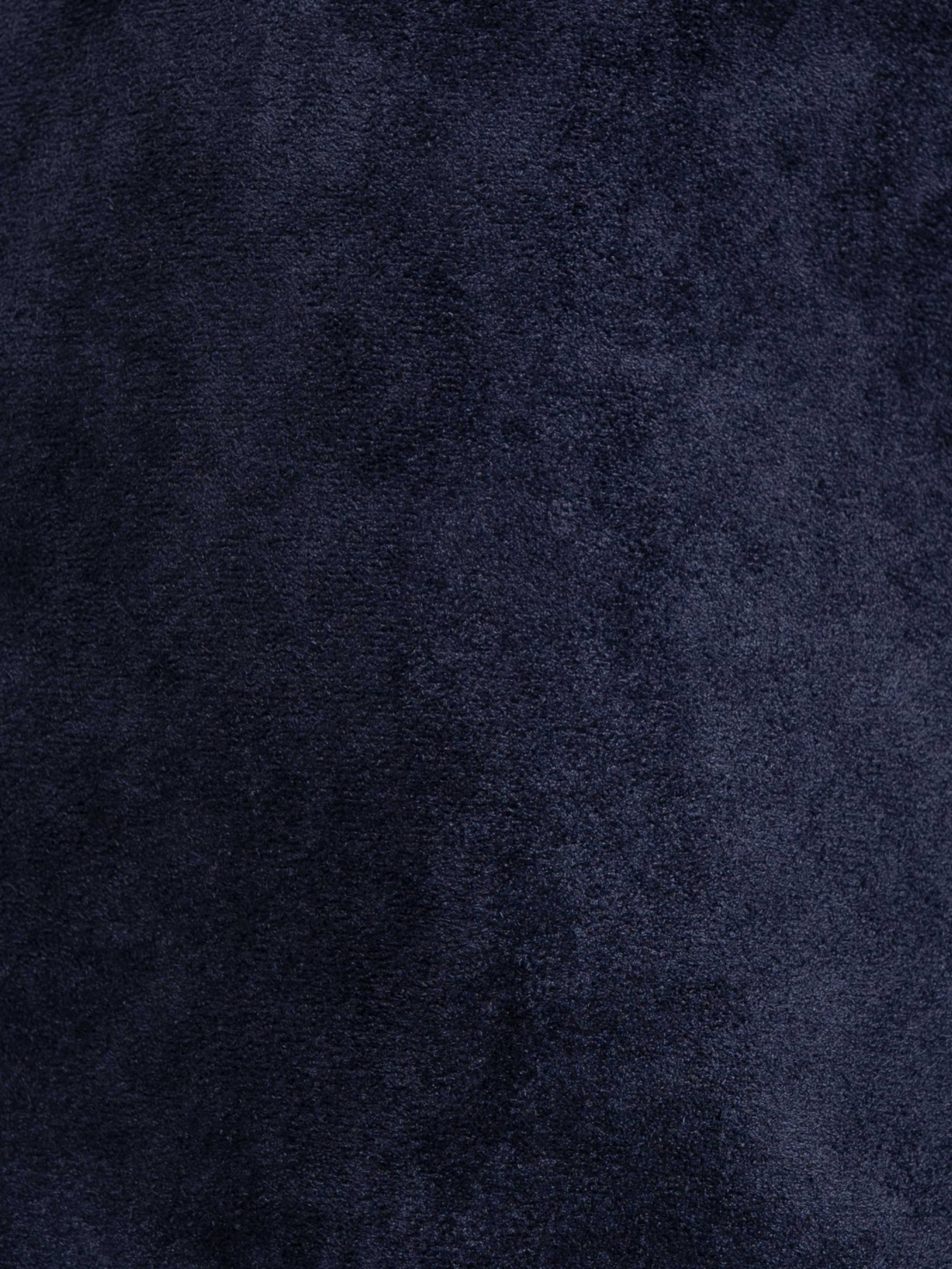 Navy blue textured men's apparel fabric close-up
