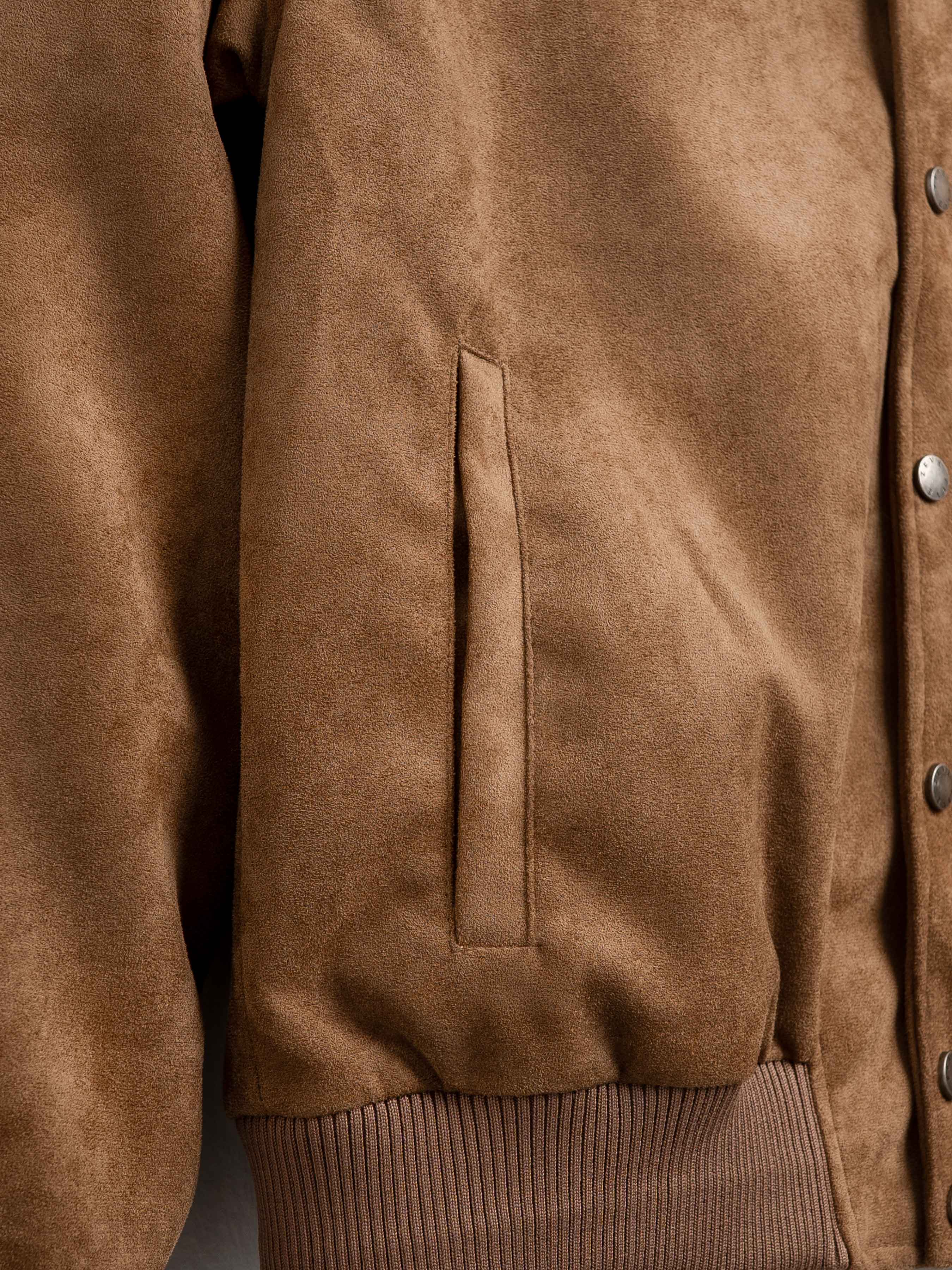 Brown suede men's jacket with button closure and ribbed hem, stylish outerwear for casual or smart looks.