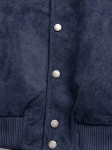 Navy blue men's jacket with textured fabric and branded buttons, stylish outerwear for formal or casual wear.