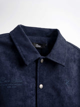 Navy blue men's suede shirt with embroidered logo and branded buttons, stylish casual wear