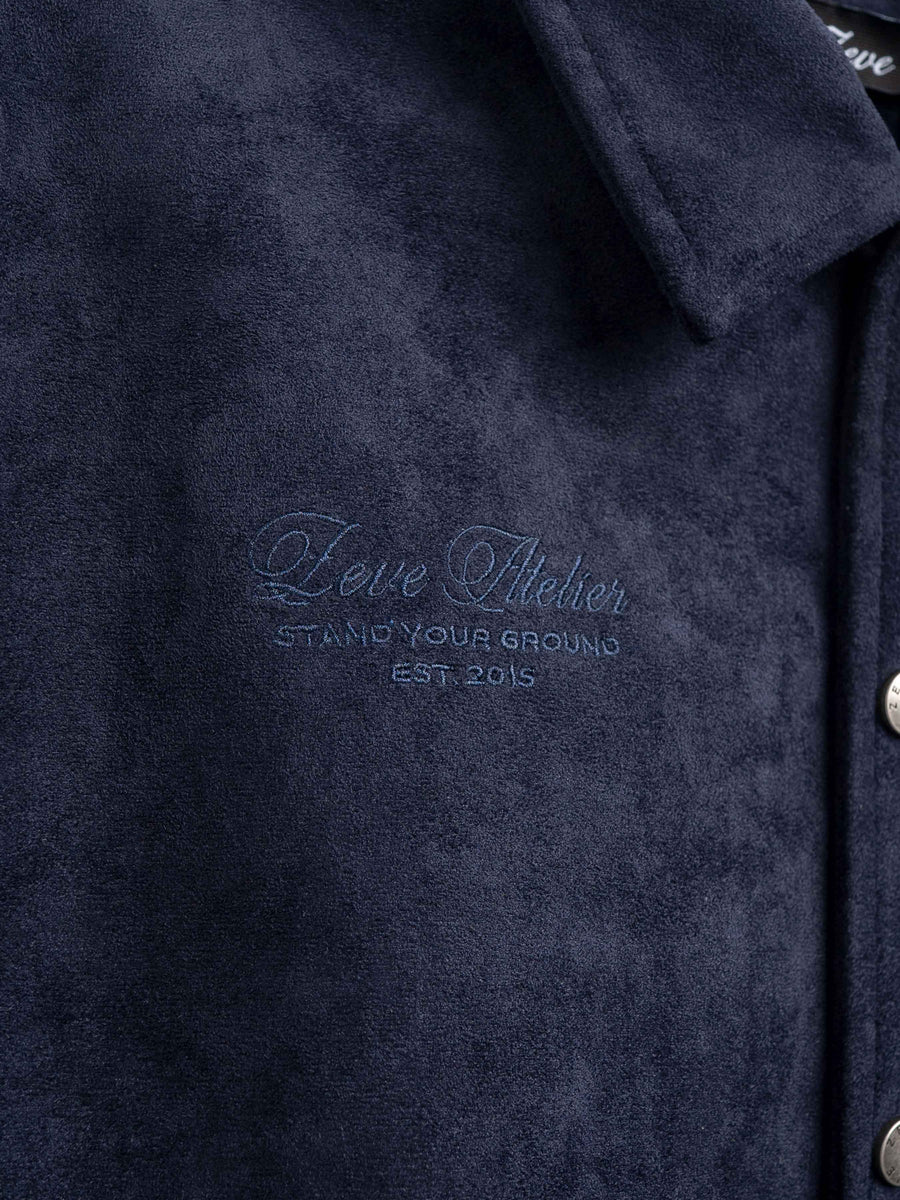 Dark navy men's coat with embroidered Zeve Atelier logo, 'Stand Your Ground Est. 2015' detail
