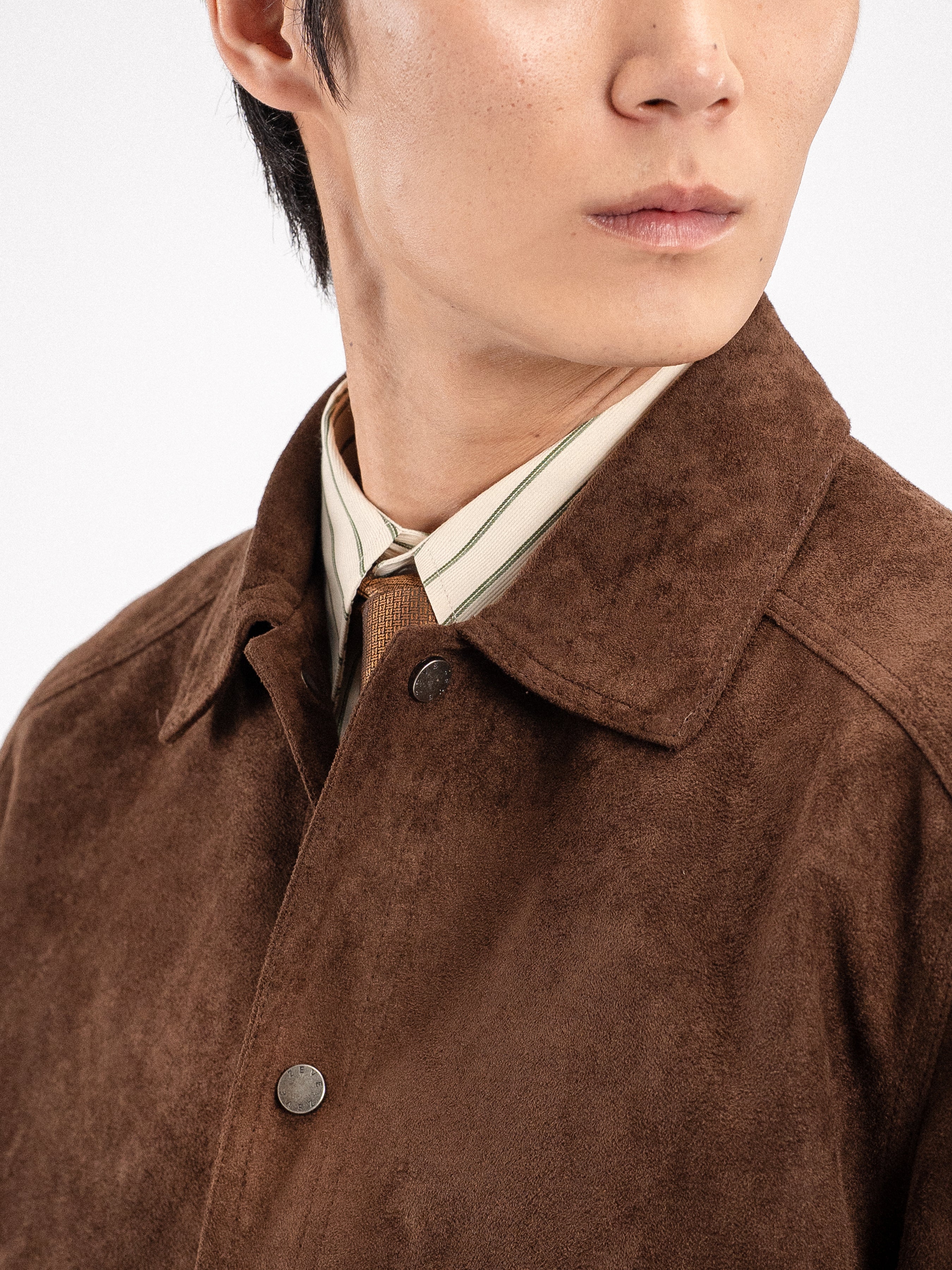 Brown suede jacket with striped shirt and patterned tie for men's stylish apparel
